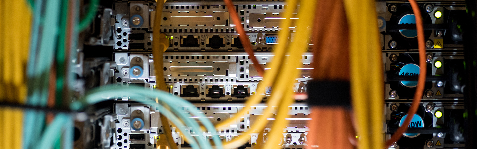 A closeup of wires and the back of a server