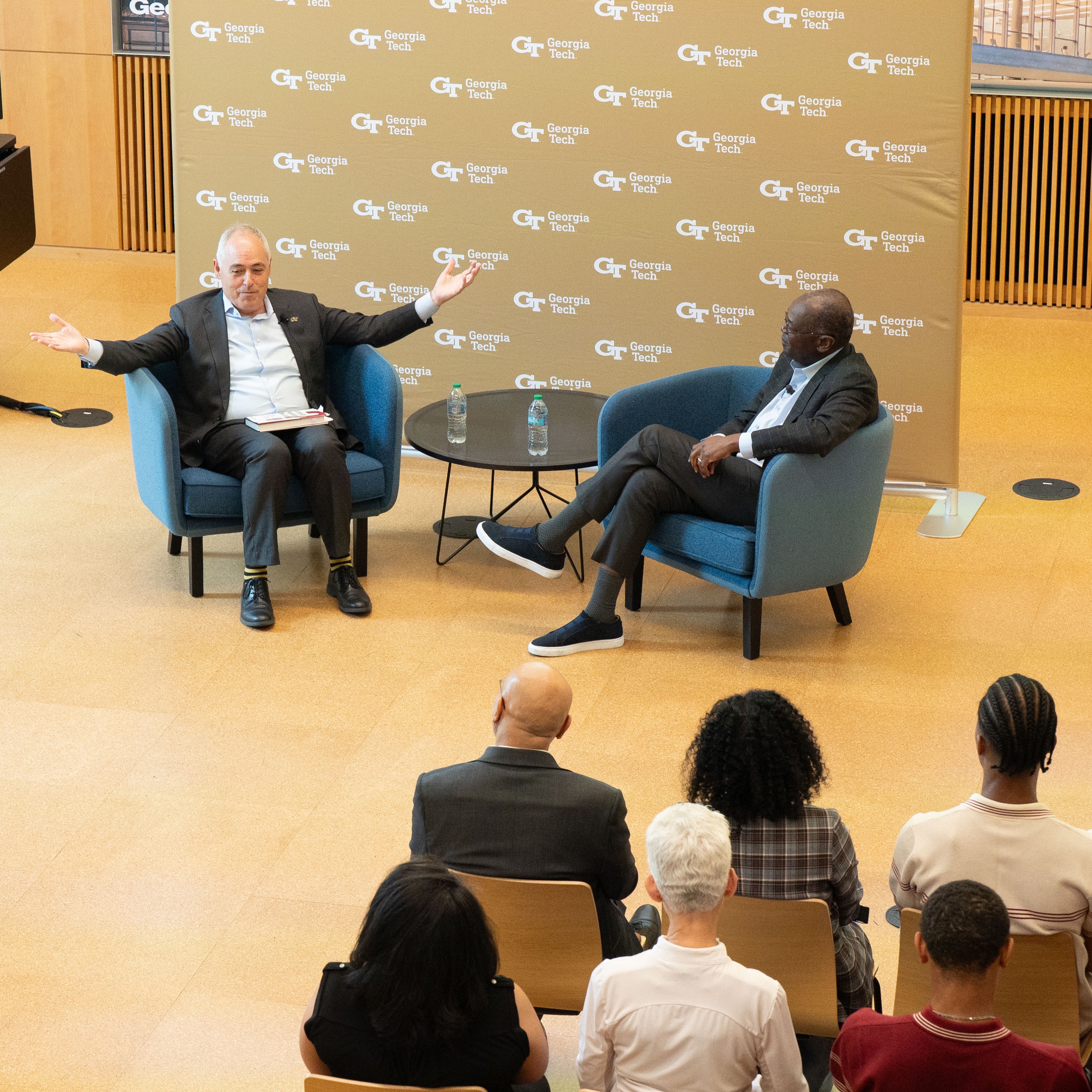 President Ángel Cabrera sits next to Rod Adkins in front of a Georgia Tech backdrop.