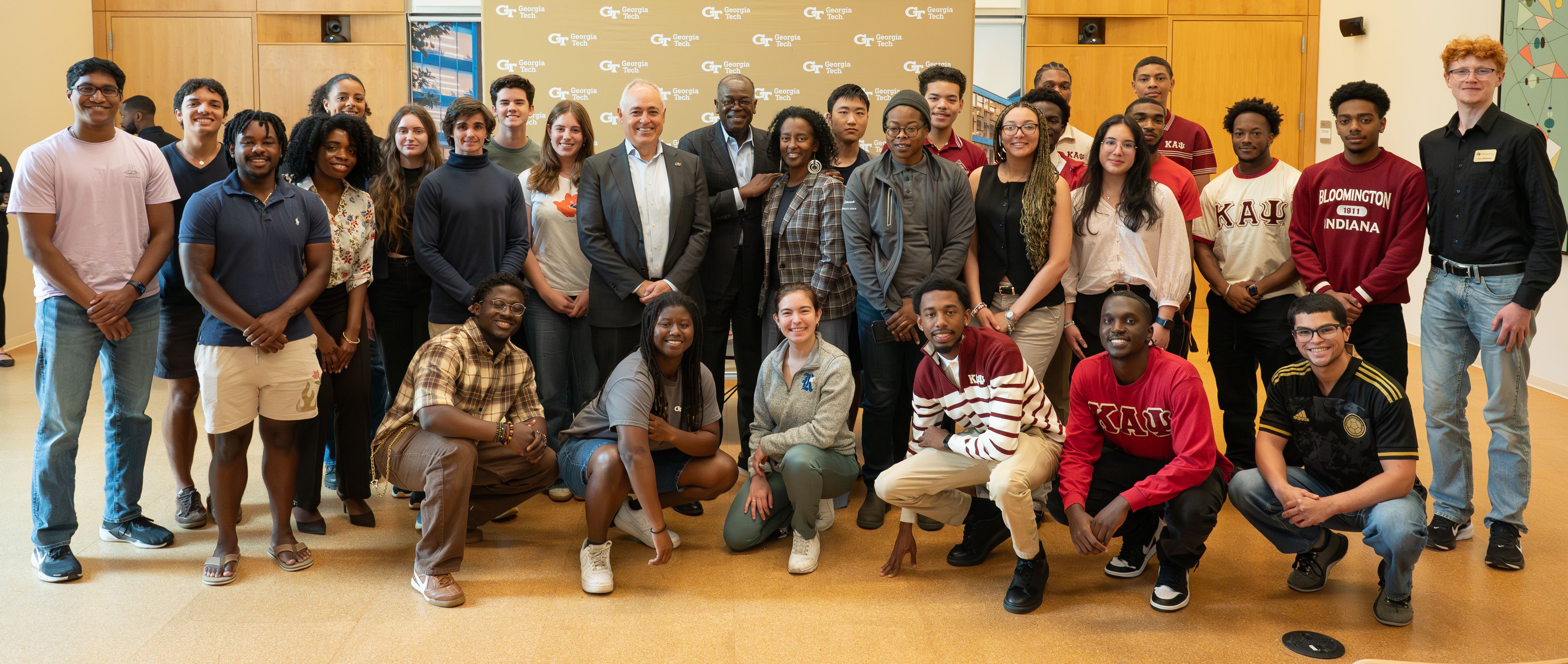 Georgia Tech students surround Georgia Tech President Ángel Cabrera who is standing next to Rod and Michelle Adkins. 